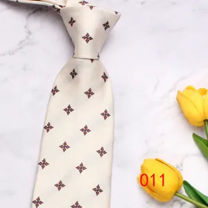 Classic beige men's tie featuring elegant floral print, perfect for business and wedding events.