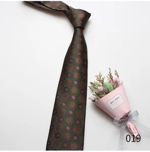 Detail view of a classic green patterned mens necktie for business and formal wear.