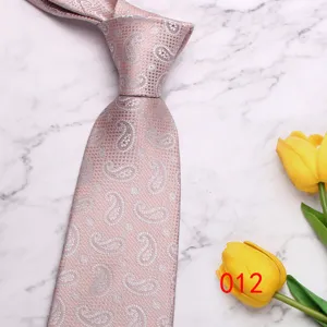 Light pink paisley necktie close-up, elegant fabric texture for business and wedding suits.