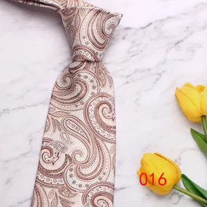 Close-up of a light paisley pattern tie detail, elegant wedding business style texture.