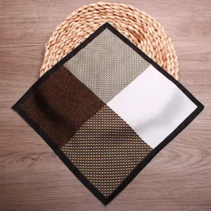 Detailed view of men's patterned pocket square with four quadrant prints and black border.