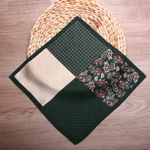 Men's dark green paisley polka dot pocket square wedding suit handkerchief accessory detail shot.