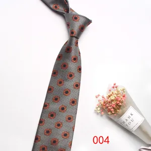 Close-up view of elegant grey business tie with orange geometric floral patterns.