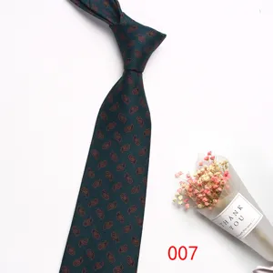 Detail view of the dark green silk business tie featuring intricate paisley pattern for men.