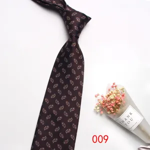 Close-up detail of classic brown paisley silk tie for men business formal wear wedding.