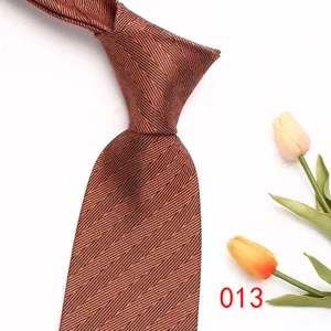 Brown men's business tie detail view, elegant chevron textured fabric for formal wear.