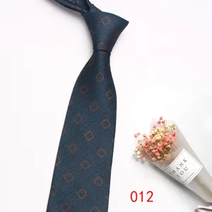 Close up detail of mens dark blue business formal tie with orange geometric square pattern.