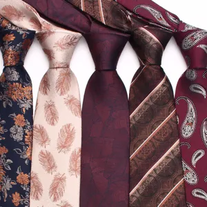 Close-up of men's jacquard woven neckties featuring assorted vintage floral and paisley patterns.