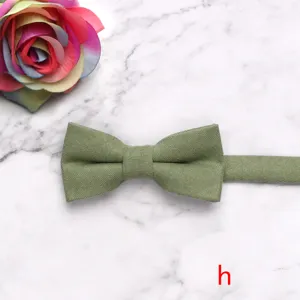Detail view of the green solid color children bow tie made of soft velvet material.