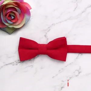 Close-up detail of the red velvet children bow tie showing soft texture and fine stitching.