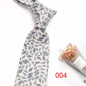 Men's silk jacquard tie detail showing vintage leaf pattern and elegant knot design.