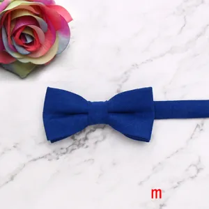 Blue velvet children's bow tie detail showing the soft fabric texture and elegant design close up.