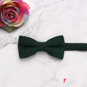 Close-up detail of dark green velvet children bow tie, soft texture, elegant design.