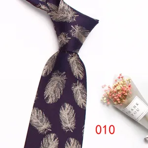 Detail of dark purple feather jacquard tie, elegant silk texture design for men's formal suit.