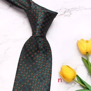Detail view of a dark green geometric floral men's business tie with elegant tulip props.