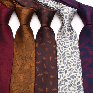 Close-up detail of assorted color jacquard silk men ties featuring elegant leaf patterns.