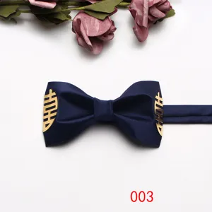 Close-up detail shot of navy blue wedding bow tie featuring gold double happiness symbol.