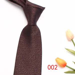 Close-up detail of men's elegant brown leaf jacquard business tie with tulip prop.