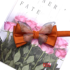 Orange satin bow tie with translucent butterfly wings, elegant accessory for formal events.