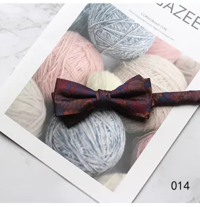 Detailed close-up of a vintage floral print bow tie on a creative yarn background.