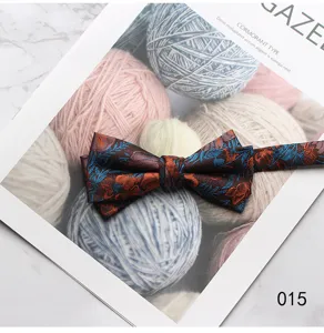 Detail shot of vintage floral mens bow tie, elegant blue orange botanical pattern for formal wear.