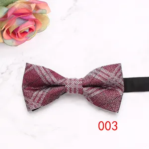 Close-up detail view of wine red plaid men bow tie with black strap for business wedding.