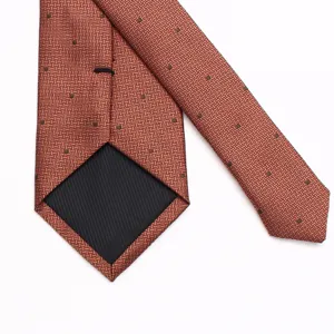 Detail view of the brown geometric patterned mens business tie showing inner lining structure.