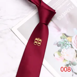 Wine red wedding tie detail shot featuring a gold double happiness pin, classic 7cm width polyester.