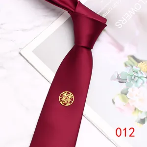 Detail view of wine red wedding tie featuring gold double happiness emblem and love 1314.