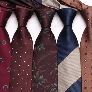 Primo piano dettagliato di eleganti cravatte da lavoro con vari motivi come pois e fiori.
