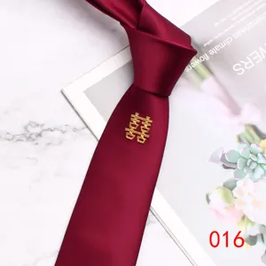 Burgundy wedding necktie detail, 7cm silk-blend fabric with golden double happiness pin.