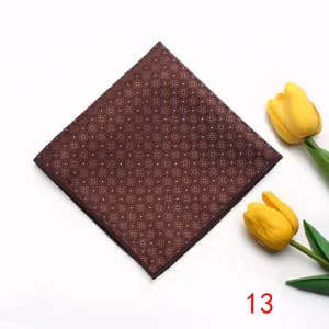 Detailed closeup view of the brown pocket square featuring elegant floral pattern and white dots.