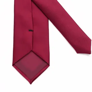 Close-up detail of the back of a solid burgundy men's necktie showing neat stitching.