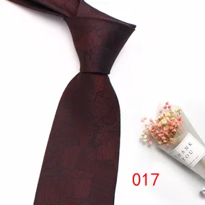 Detailed view of burgundy men's business jacquard tie with vintage leaf pattern design.