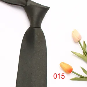 Dark green silk tie close-up, classic paisley pattern detail for business men formal wear.