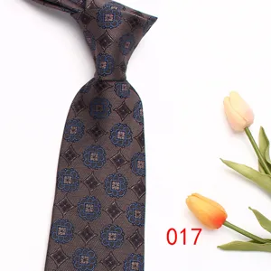Exquisite men's business tie featuring detailed blue geometric floral pattern on brown fabric detail.