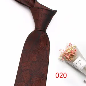 Detailed view of the dark brown jacquard business necktie featuring elegant plant leaf pattern.