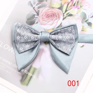 Detailed close-up of a stylish grey double layer mens bow tie with geometric pattern.