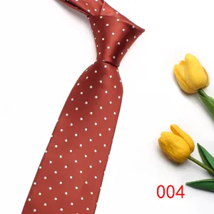 Red silk polka dot tie detail shot, classic British style accessory for formal and casual wear.