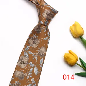 Detail shot of brown floral tie featuring silver-grey flower pattern with yellow tulip prop.