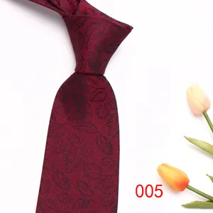 Close-up detail of the burgundy men tie featuring elegant leaf jacquard pattern texture.