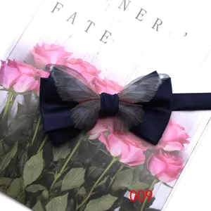 Navy blue bow tie with sheer butterfly wings, elegant wedding party shirt suit accessory.