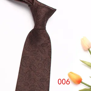 Brown men jacquard tie detail showing elegant leaf pattern and fine texture for business.