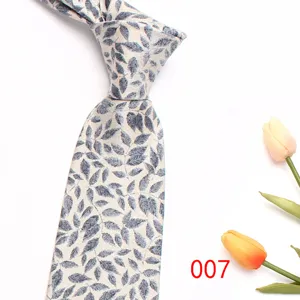 Close-up of men's gray leaf pattern jacquard tie with tulip prop, elegant business style.