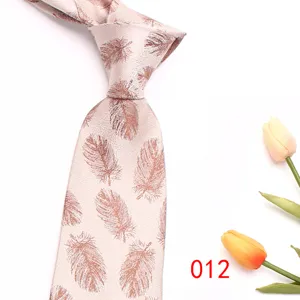 Close-up detail of the elegant pink jacquard feather pattern necktie for men's business wear.