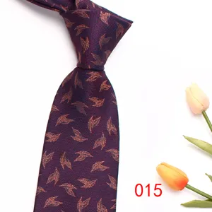 Close-up detail of a dark purple men's jacquard silk tie featuring a leaf pattern.