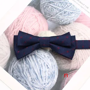 Vue détaillée de l'élégant noeud papillon double bleu foncé à motif rouge pour occasions formelles.