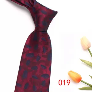 Men's burgundy jacquard necktie detail, classic business formal silk tie design for work.