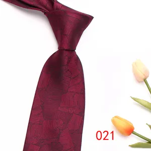 Burgundy red men's business formal jacquard tie detail view showing elegant leaf pattern texture.