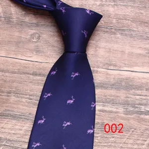 Close-up detail of dark blue men's tie featuring elegant purple rabbit pattern design.